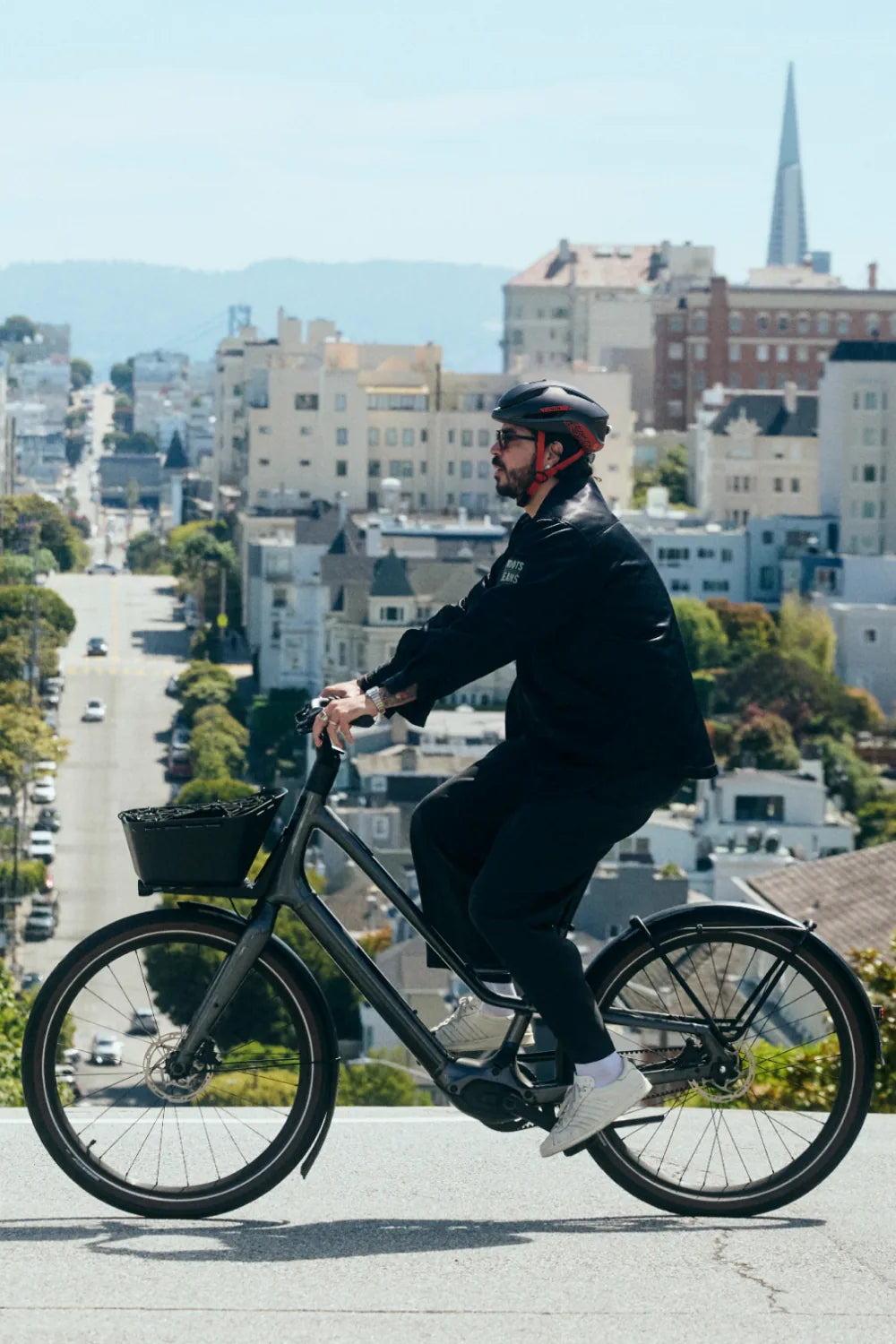 Rider on a city bike above San Francisco wearing Lumos Aero GT in Race